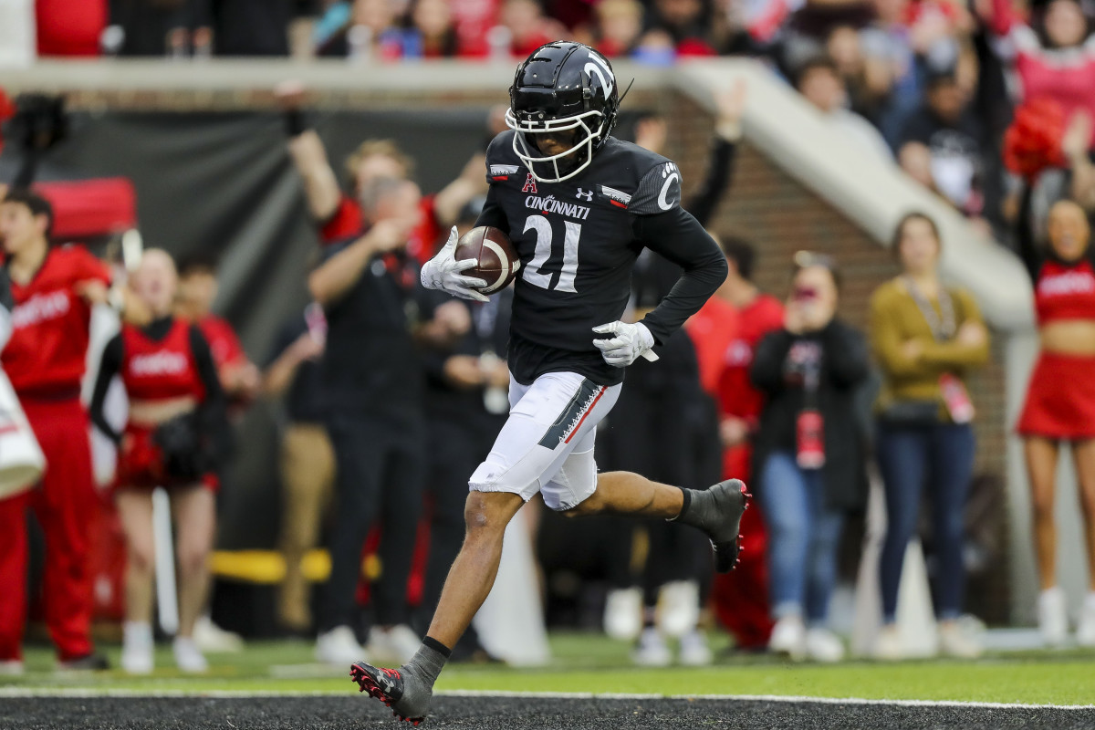 Nov 5, 2022; Cincinnati, Ohio, USA; Cincinnati Bearcats wide receiver Tyler Scott (21) runs the ball in for a touchdown against the Navy Midshipmen in the first half at Nippert Stadium. Mandatory Credit: Katie Stratman-USA TODAY Sports
